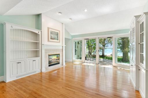 Vaulted Living Room features whimsical details from floor to ceiling. Embrace Nature! Note that the doors open fully to communicate to the yard.