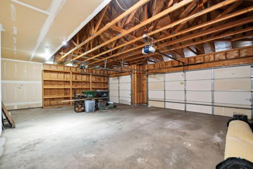Inside the attached 3 car garage with built-in storage shelves. Firewood to stay.