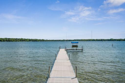 Non-slip aluminum dock features a relaxing canopied bench & convenient ladder.