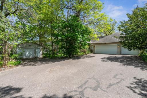 Detached extra garage with work bench. Great for lake toys & tools. Large driveway offers additional off street parking.