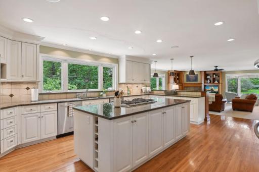 Cooks kitchen with large island, extensive storage, stainless appliances and breakfast bar. All open to first floor family room