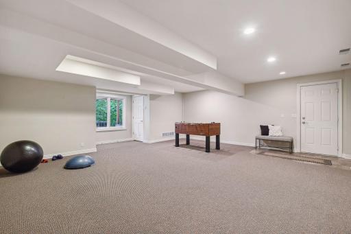Multi-purpose room for recreation or workout, connects to heated, 3-car garage
