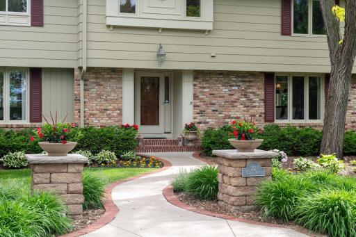 Pillars and walkway with brick soldiers border lead to the front door