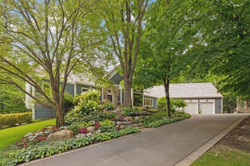 Beautiful mature trees add seclusion as you enter the property