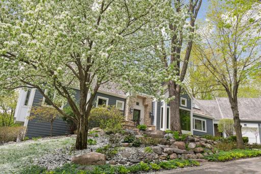 Flowering crabapple trees surround the entrance
