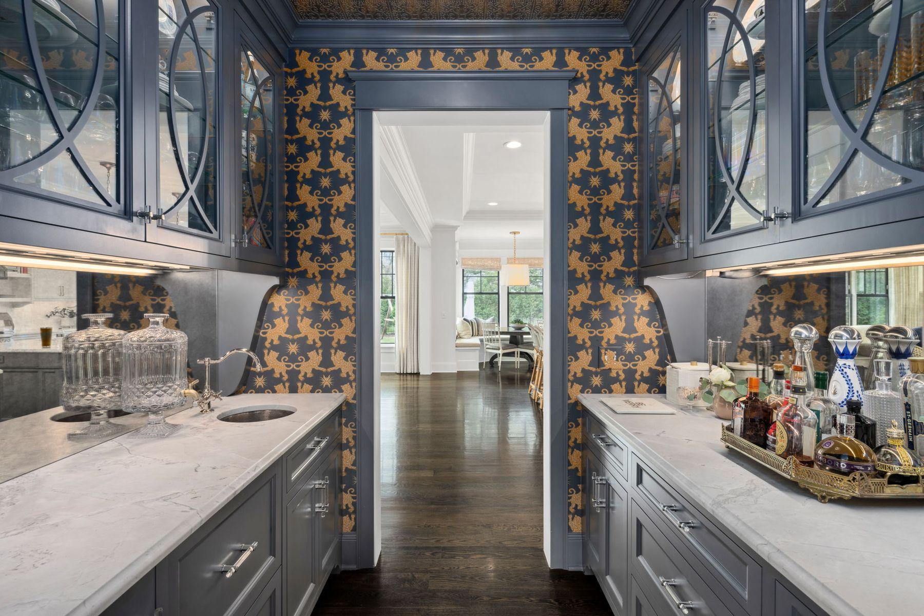 Butler's pantry with antiqued mirror backsplash and refrigerated drawers.