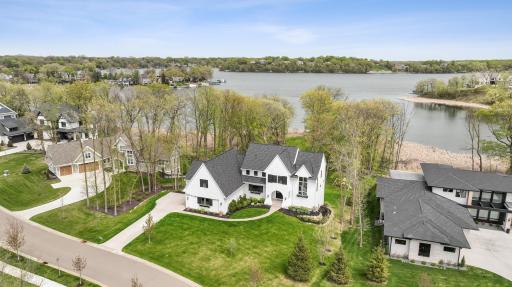 This immaculate 2-story residence rests on over an acre of prime Halsted Bay shoreline, offering unparalleled views and access to the pristine waters of Lake Minnetonka.