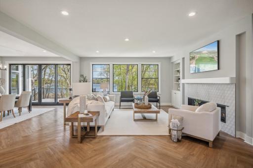 Photo for 3722 Woodland Cove Parkway, Minnetrista, MN 55331 - Listing #6533987 Enter through grand French doors into a world of luxury, where stunning herringbone-style LVP floors and lofty 9-foot ceilings grace the main level, setting a tone of sophistication and refinement.