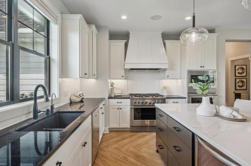 Photo for 3722 Woodland Cove Parkway, Minnetrista, MN 55331 - Listing #6533987 Revel in the luxury of soft-close cabinetry with elegant under-cabinet lighting, complemented by dazzling quartz countertops and a chic subway tile backsplash.
