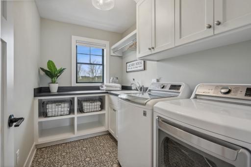 Photo for 3722 Woodland Cove Parkway, Minnetrista, MN 55331 - Listing #6533987 Upstairs laundry room with utility sink, countertops, and storage enhances daily living.