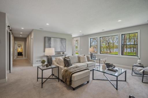 Photo for 3722 Woodland Cove Parkway, Minnetrista, MN 55331 - Listing #6533987 Expansive walk-out family room boasting state-of-the-art surround sound, perfect for unforgettable movie nights or lively game gatherings.