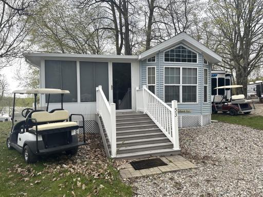 Park model with large porch...golf cart included