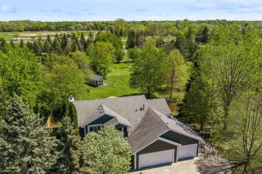 Aerial view of the gorgeous 2.19 acre wooded private lot. Fully fenced backyard. Cement Board exterior siding with fresh paint. Updated Andersen Windows throughout the home