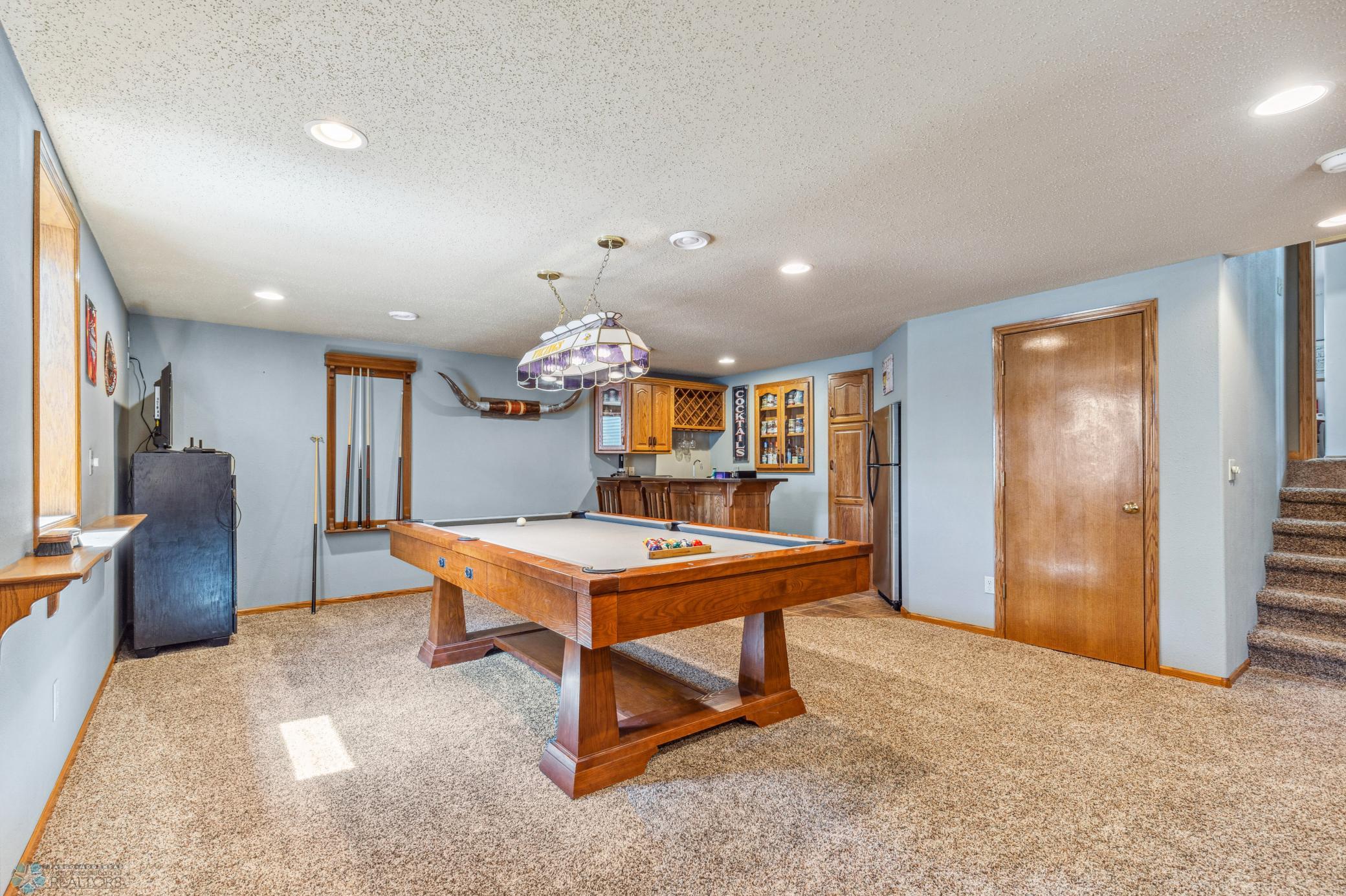 Basement Family room with a wet bar and pool table included.
