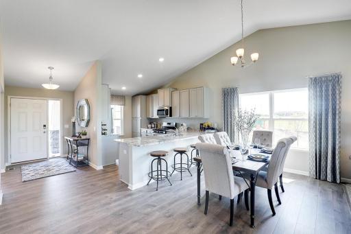 Open concept living at it's best with the vaulted main level ceilings! Photos of model home. Colors and options may vary. Ask Sales Agent for details.