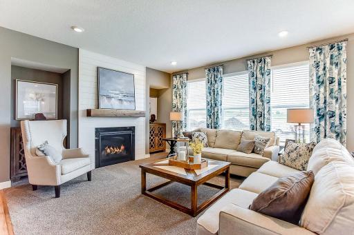 A great view of this cozy living room on the main level. MODEL HOME PHOTOS, COLORS AND SELECTIONS WILL VARY.