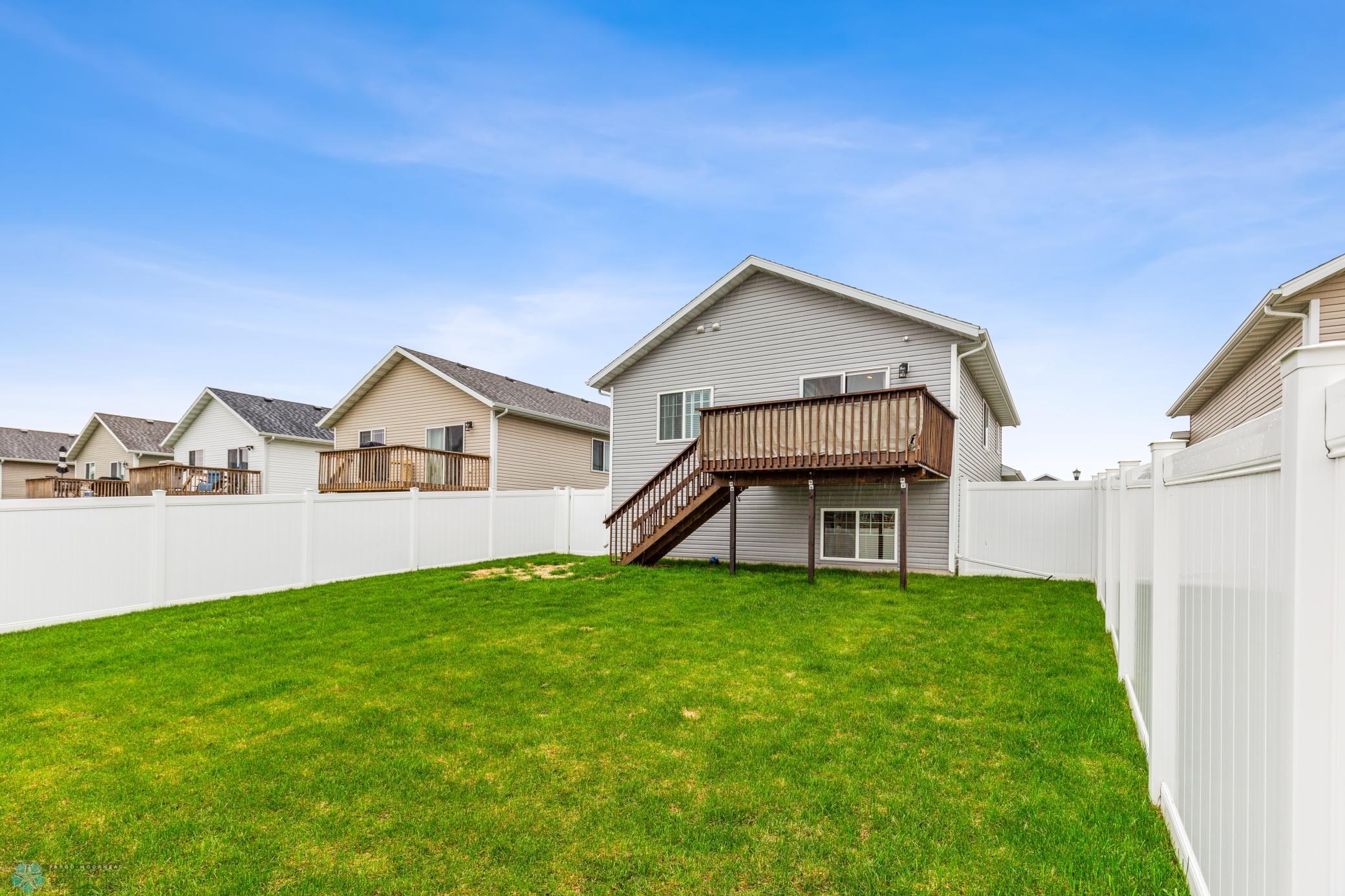 fenced yard with deck