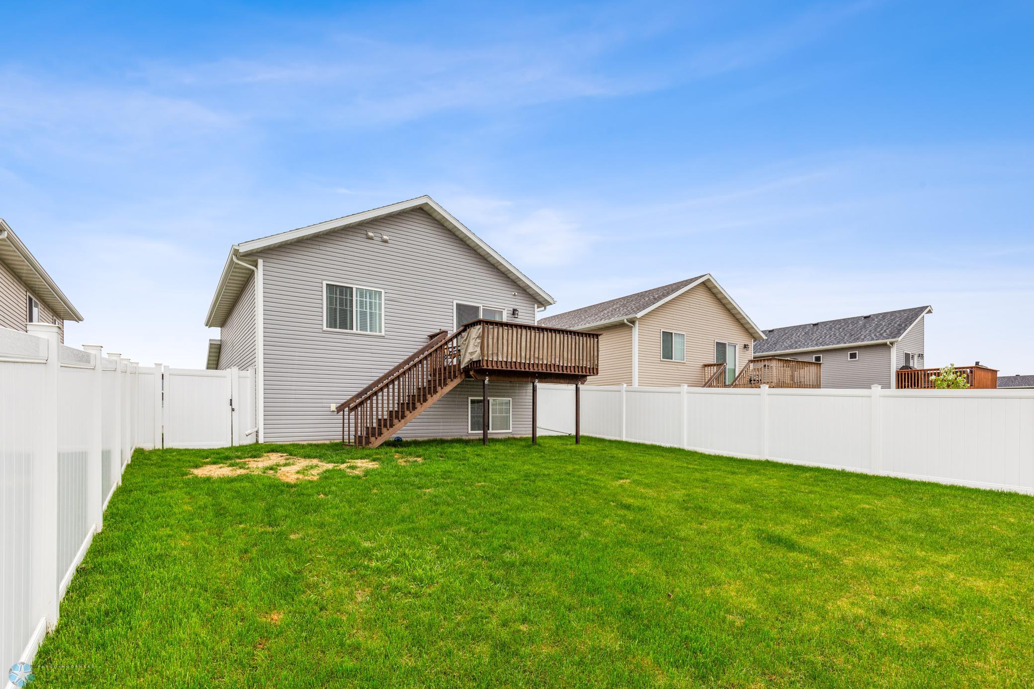 fenced yard with deck