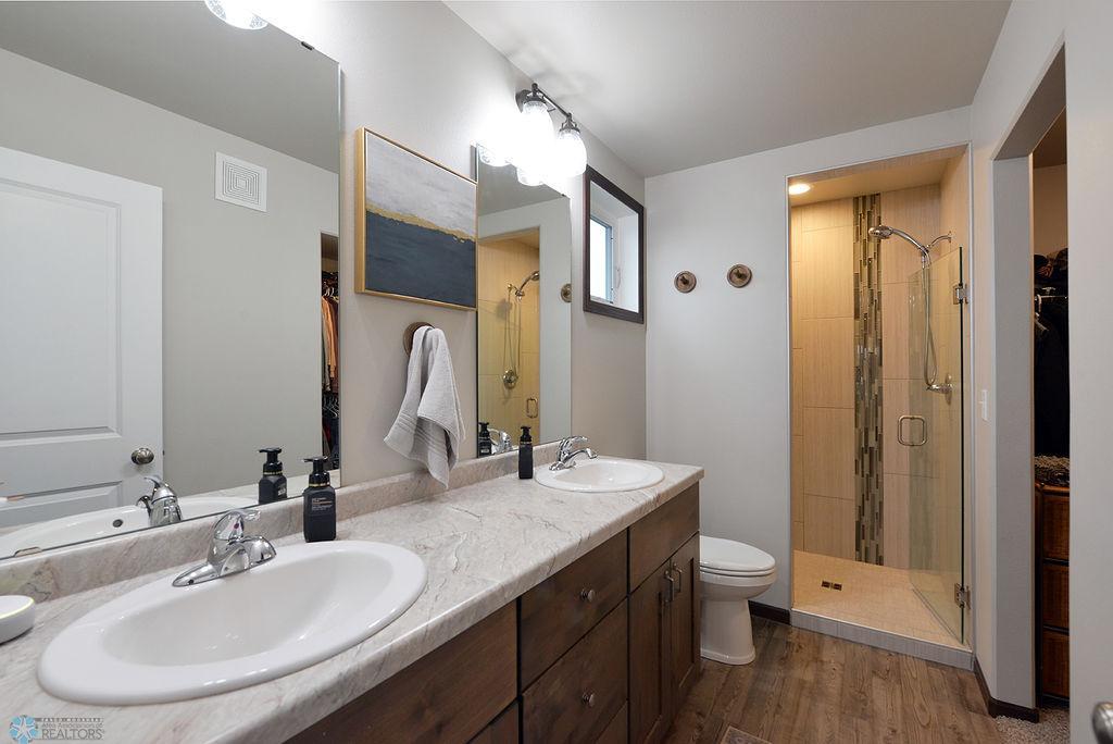 Primary bath with tile walk-in shower & double sinks