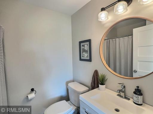 The main level bathroom highlights functionality & style, just across the hall from the bedroom.