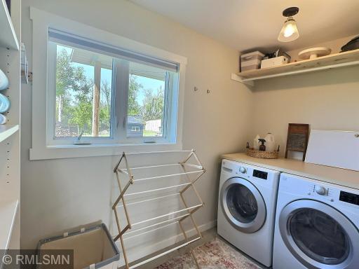 Stay organized in the laundry room with open shelving in the entryway and a folding table.