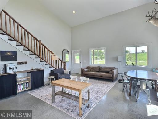 Gather in the vaulted living room with an additional door leading to the outdoors and patio.