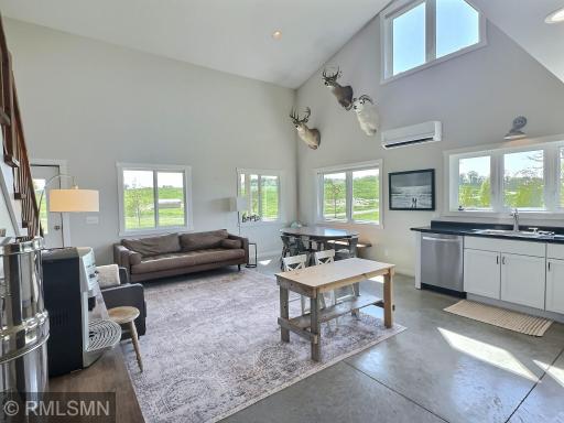 A comfortable home opens to soaring ceilings, sleek cement flooring and fantastic natural light.
