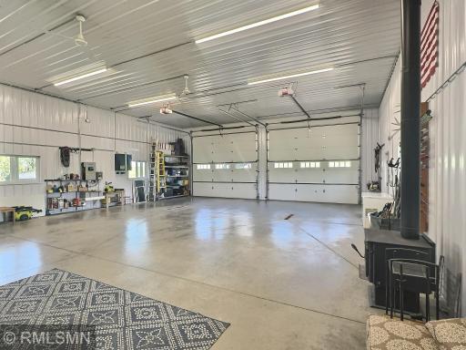 35x42 parking space with double overhead doors and wood burning stove lead into the home.