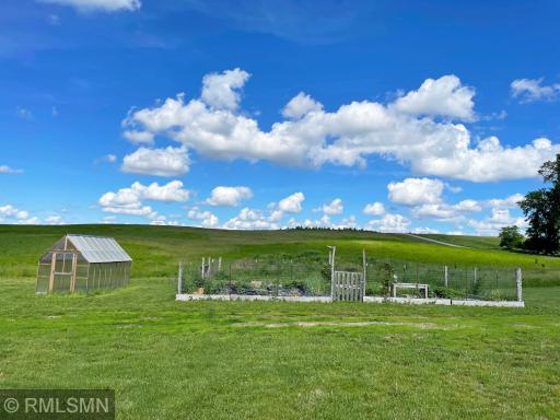 Your green thumb will thank you for this. Garden beds with fencing and a green house is ready!