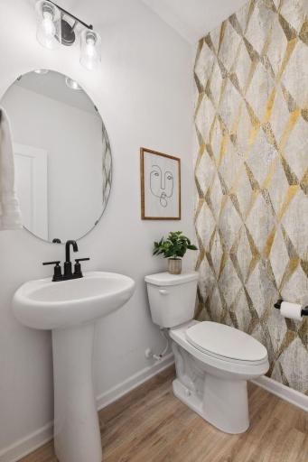 DThe guest bath on the main level offers a designer touch with custom wallpaper