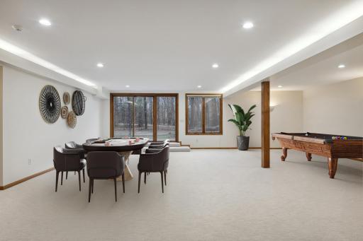 The fun continues in the amusement and game areas. Set this space up with a variety of games for hours of entertainment! The walkout leads to the side yard and tennis/pickle ball court which the sellers flooded in the winter for ice skating.