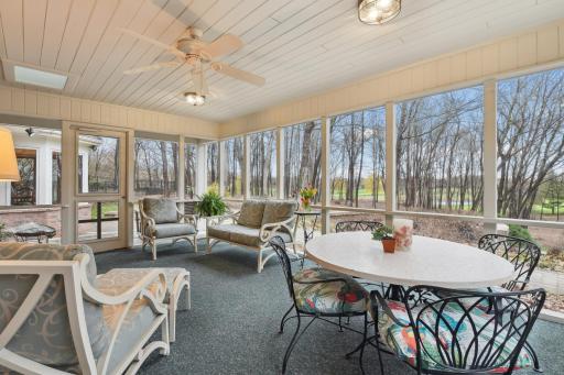 Wrapped in garden and backyard views, the porch offers access to the patio