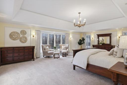 The primary suite offers sufficient space for a sitting area in addition to bedroom furniture