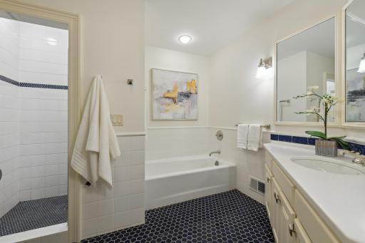 The main floor hallway bath has been nicely updated with tile flooring, shower and tub surround.