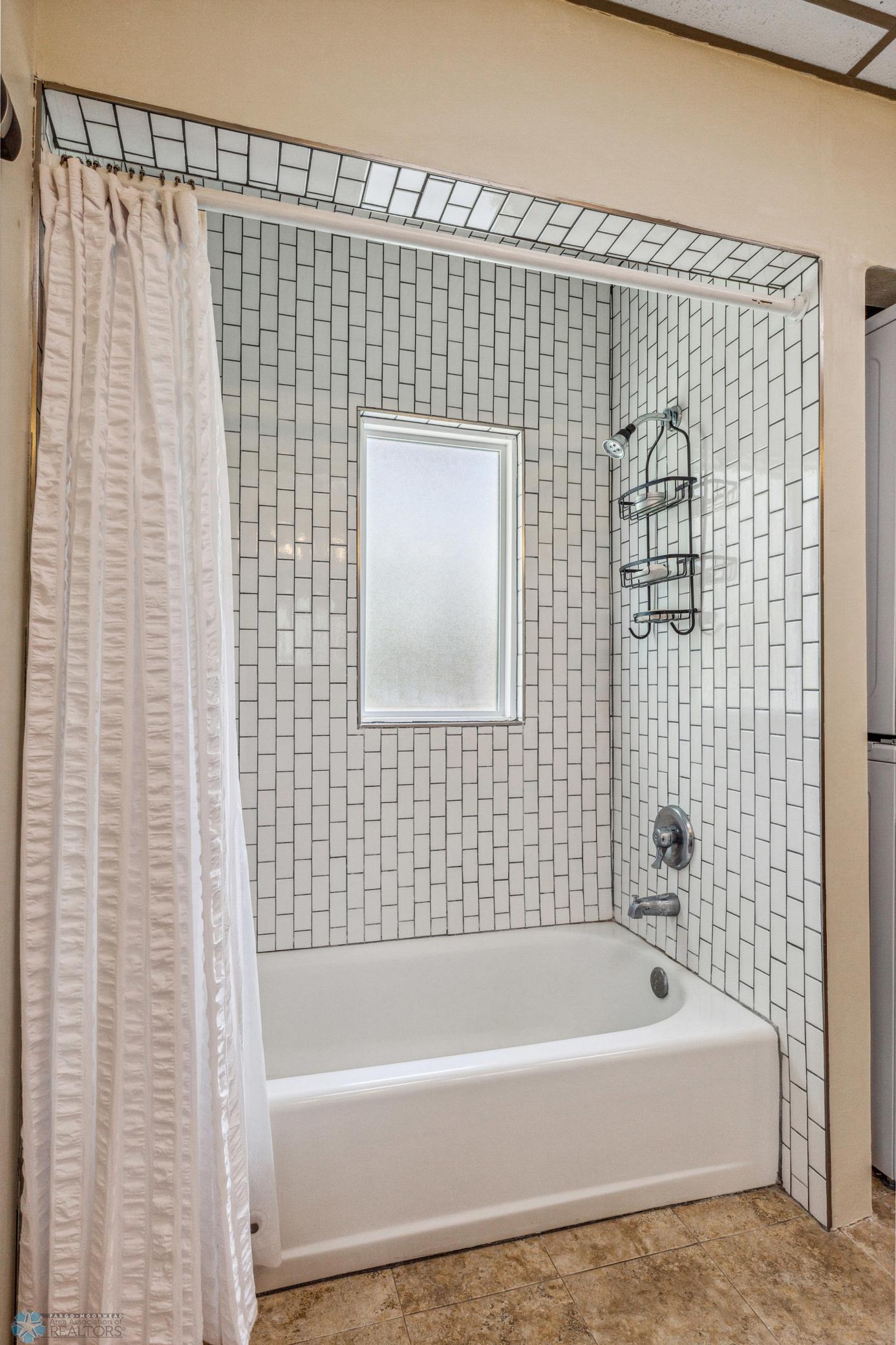 Gorgeous tiled tub - with privacy and light!