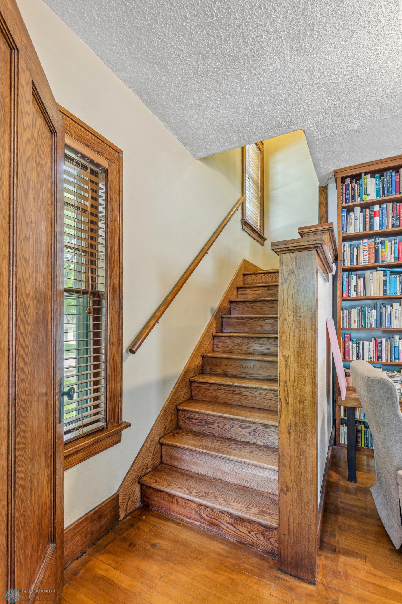 Stairs - lovely original hardwood floors and original trim work in this turn of the century home