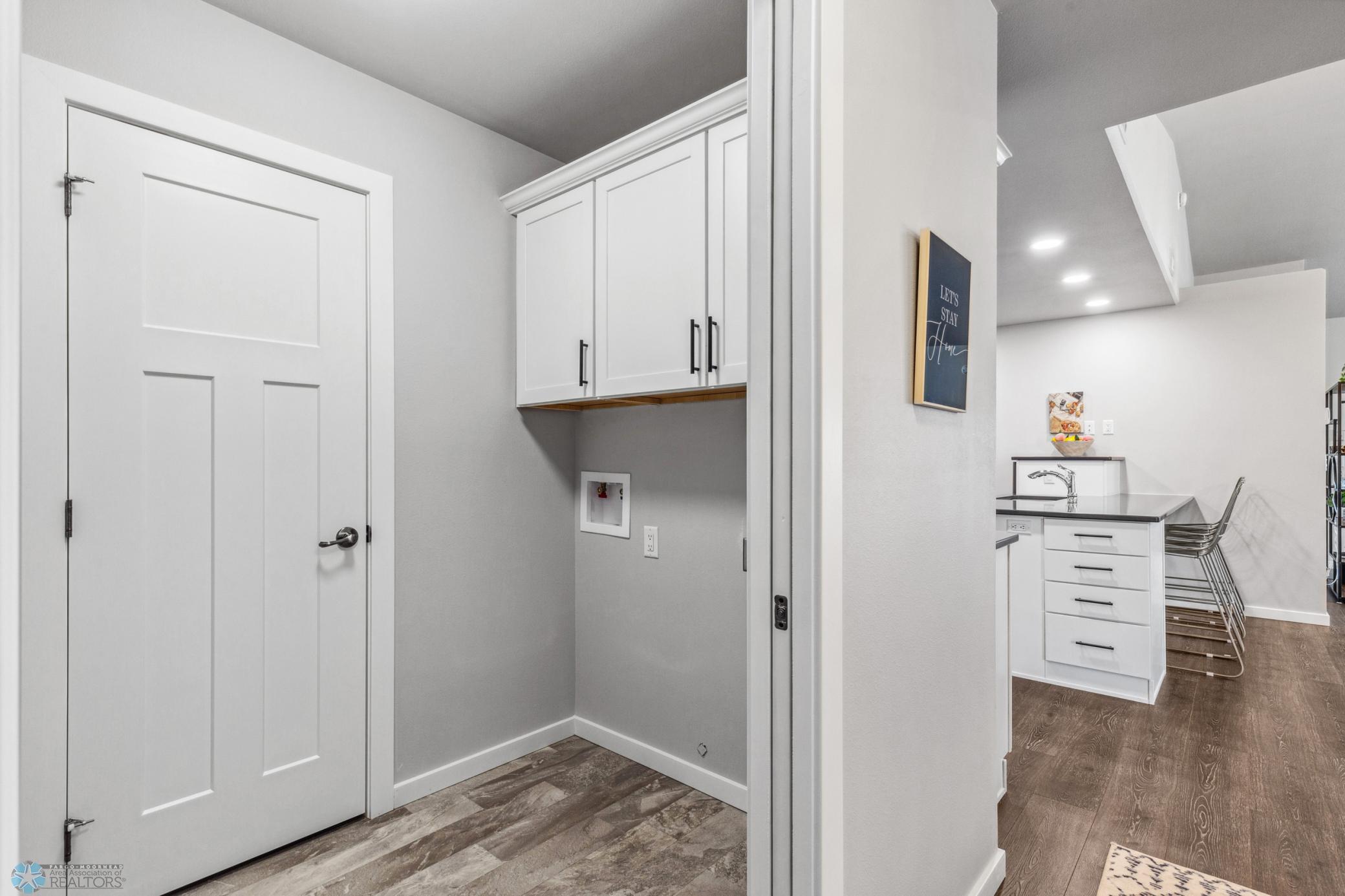Laundry - with cabinetry for storage. (Door to utility room.)