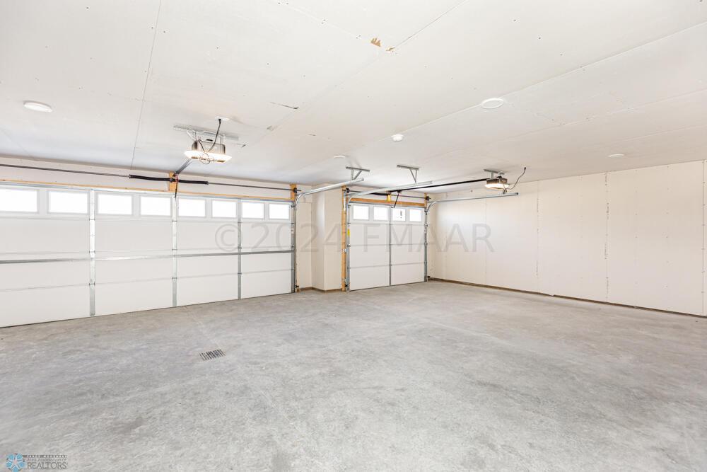 3car Garage: Insulated, with Glass Panels in the overhead doors and a floor drain too!