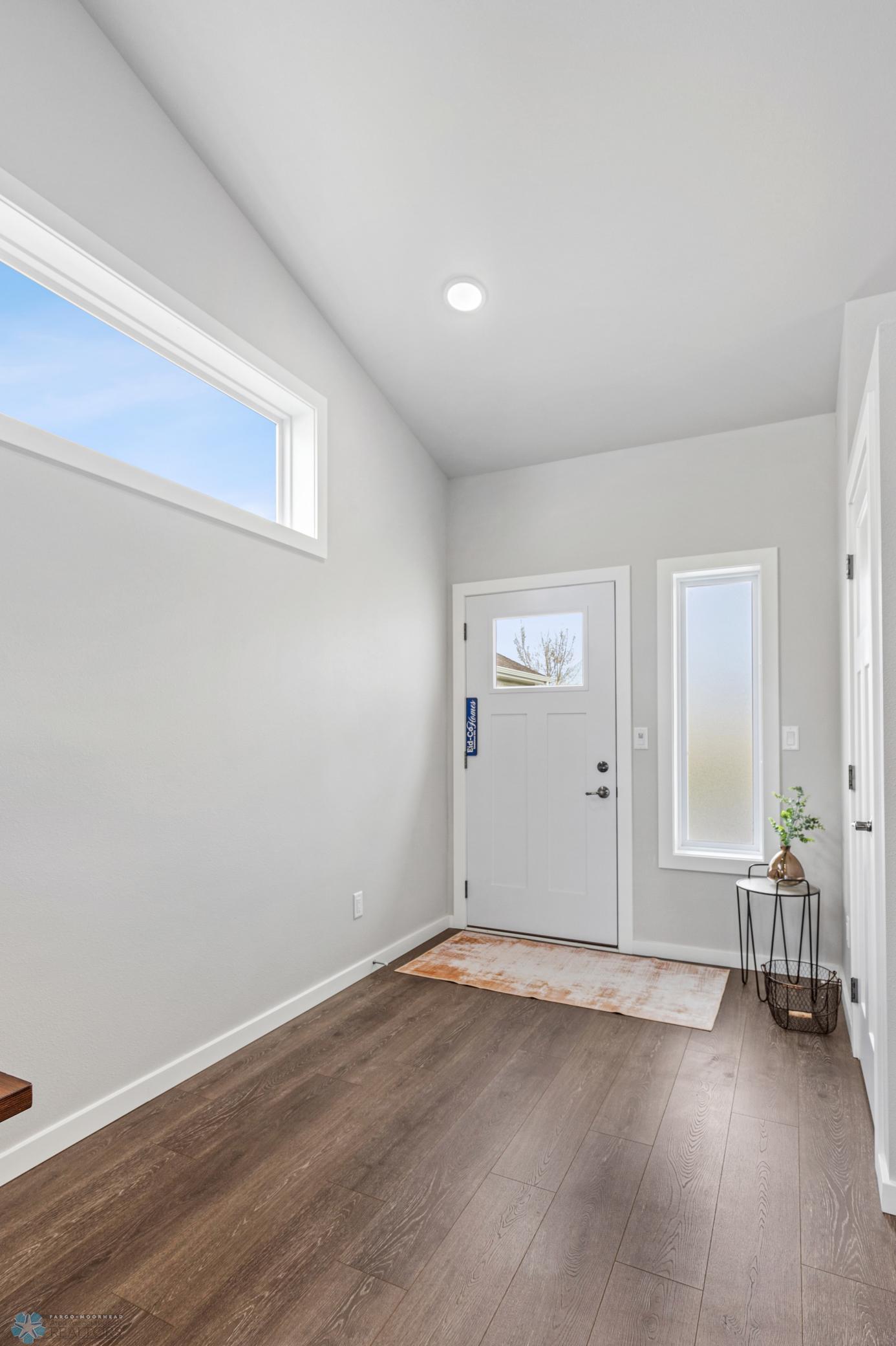Spacious Entry with coat closet and room for a chair or bench.