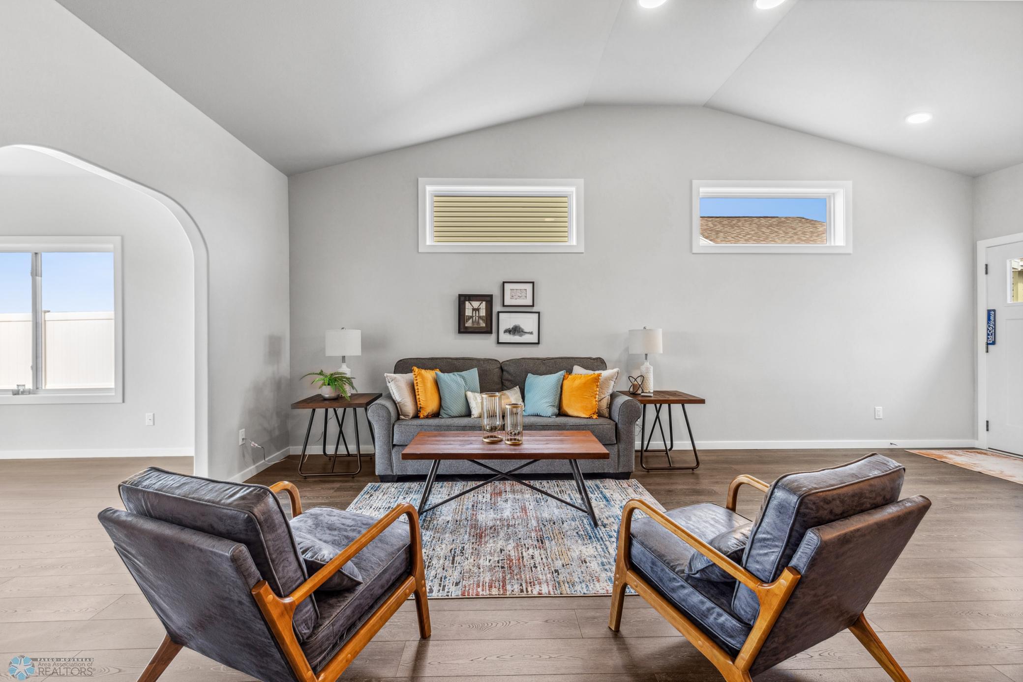 Continuous laminate flooring through the living, kitchen, sunroom, dining and foyer.