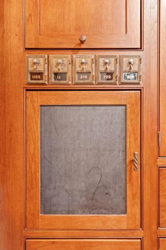 Built-in hickory cabinets include a salvaged mail locker and inset doors