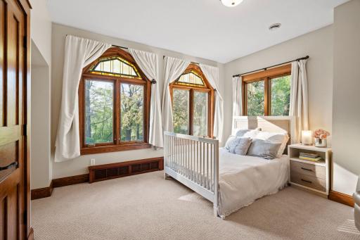 Bedroom 2 offers decorative stained transom windows that bring in natural light