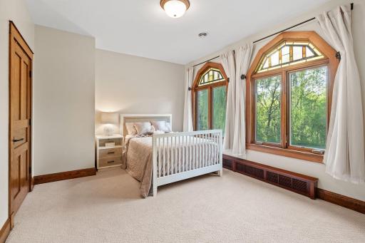 Bedroom 3 offers decorative stained glass transom windows