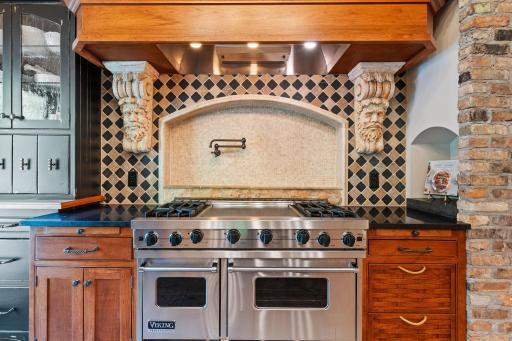 High end appliances include a paneled refrigerator, 48" Viking gas range with oversized paneled hood, paneled bosch dishwasher, paneled beverage refrigerator and microwave