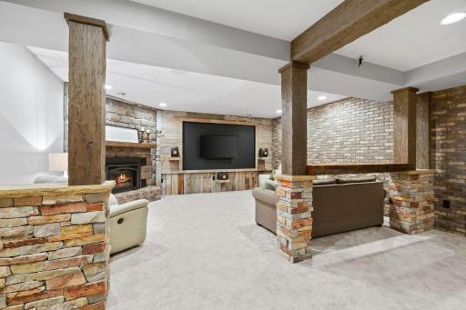 Lower level Family Room features brick and barwood accent walls