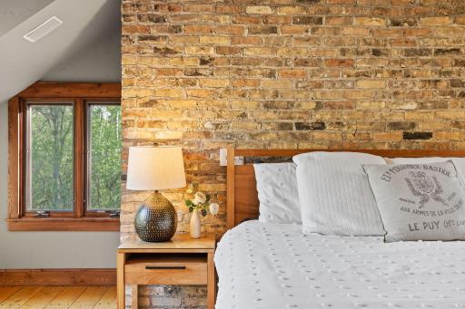Chicago brick accent wall and dormer attic angled ceilings