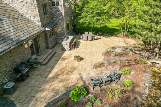 Professionally landscaped and offers limestone retaining walls, paver and stone paths, mature trees and shrubs, and stunning mulched perennial gardens.