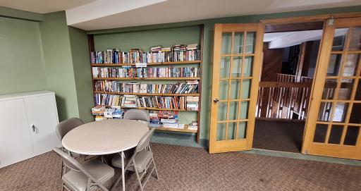 The party/community room has a small library with books, games, and puzzles.
