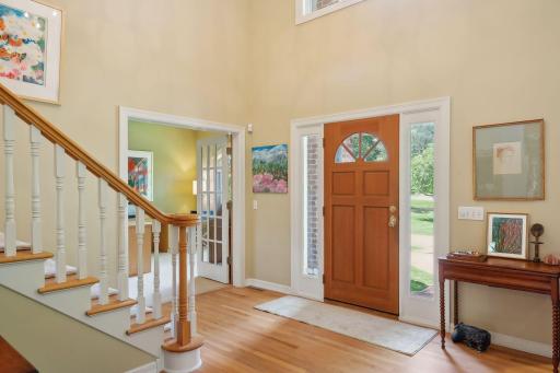Large Foyer with hardwood floors and high ceilings