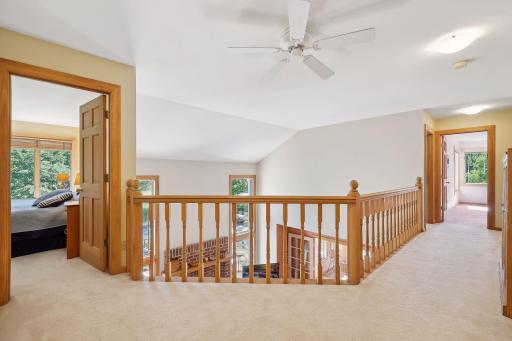 Split hall upstairs leading to Primary Suite plus 3 additional Bedrooms and bonus Yoga Room